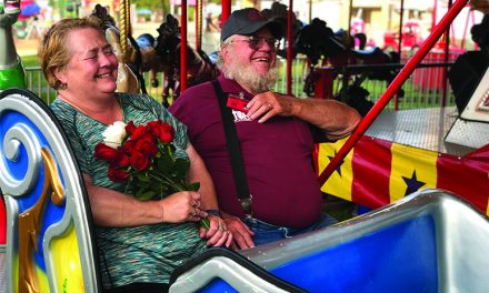 Longtime Fair Board member  renews vows on Merry Go Round