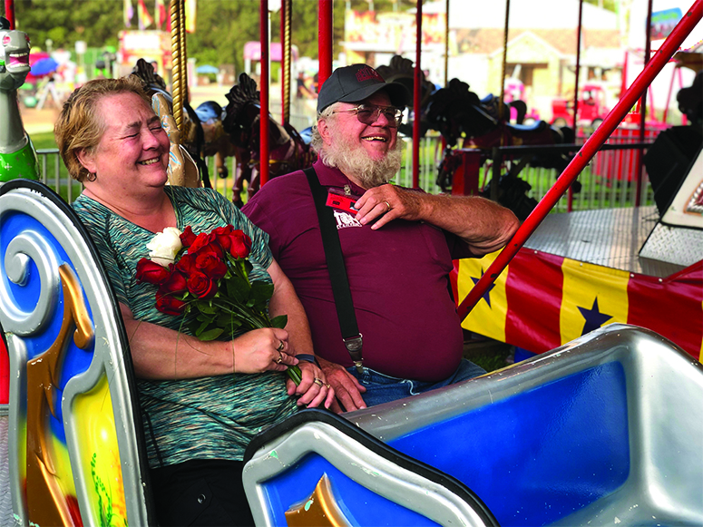 Longtime Fair Board member  renews vows on Merry Go Round